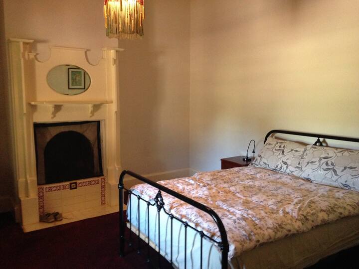 Main bedroom with queen bed and fire place.