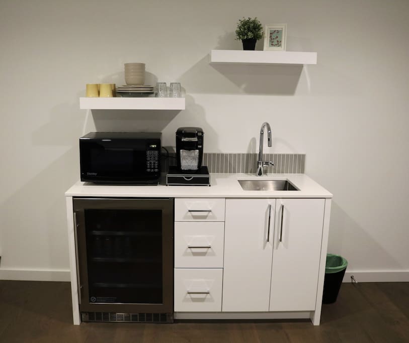 Modern Kitchenette with mini fridge, coffee maker, hot plate, utensils, and other basics