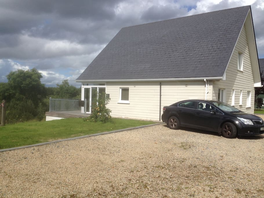 Side view of house (entrance on left). Plenty of parking!