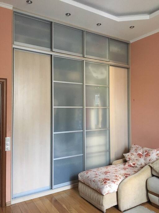 Bedroom-1 (studio couch, single bed, piano, bookshelves, TV, large wardrobe)