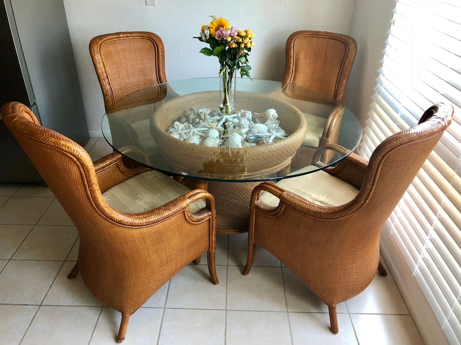 Beautiful Tommy Bahama dining table with seashells inside and fresh flowers every week!