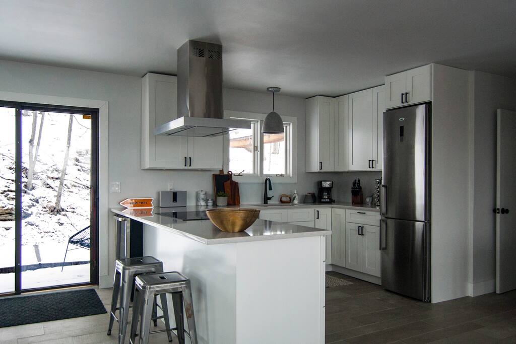 Gourmet kitchen with oven, microwave, coffee maker, blender and more.