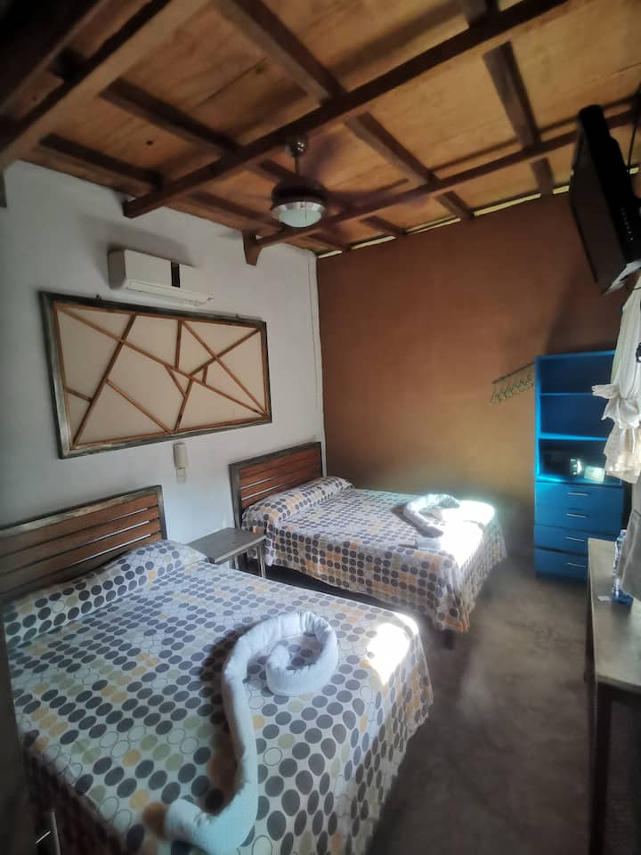 Your bedroom, with acc, fan, tv and safety box, view to your own terrace and garden.