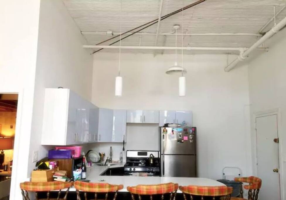 The kitchen is fully equipped with microwave, oven, toaster