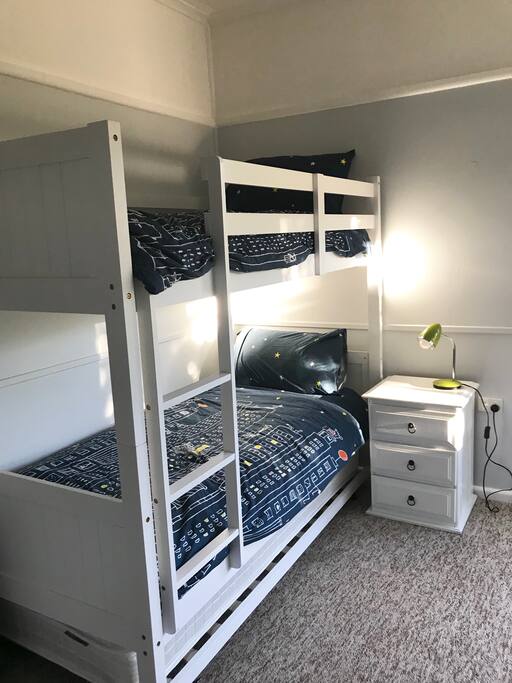 Large bunk room that has 2 bunks and 2 rollaway beds, accommodating 6 people.