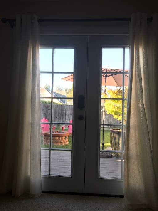 French doors open to a deck bathed in morning sun (or fog) and a perfect place for a cozy cup of local coffee.