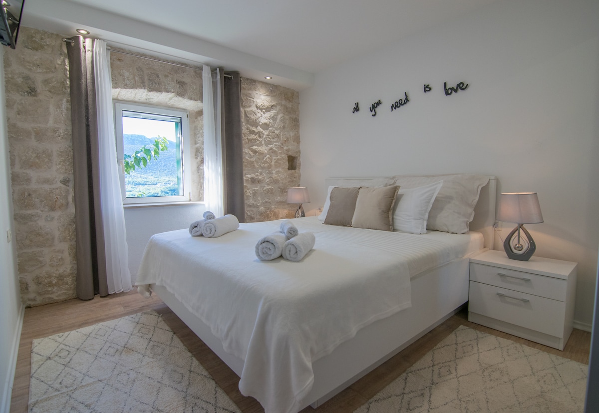 ห้องนอนที่อบอุ่นพร้อมการตกแต่งที่ดีทีวีและพัดลมเพดาน