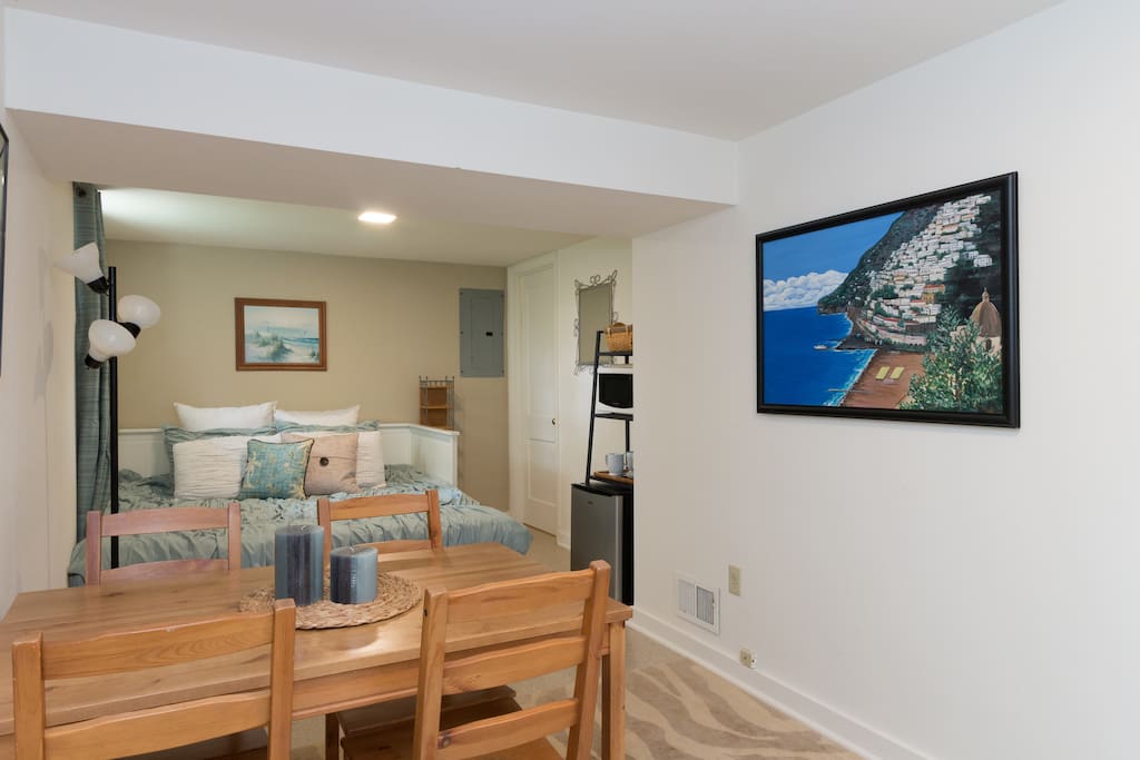 View upon entering suite...table for 4, bed adjusted to King size, corner with fridge, microwave, and beverages.