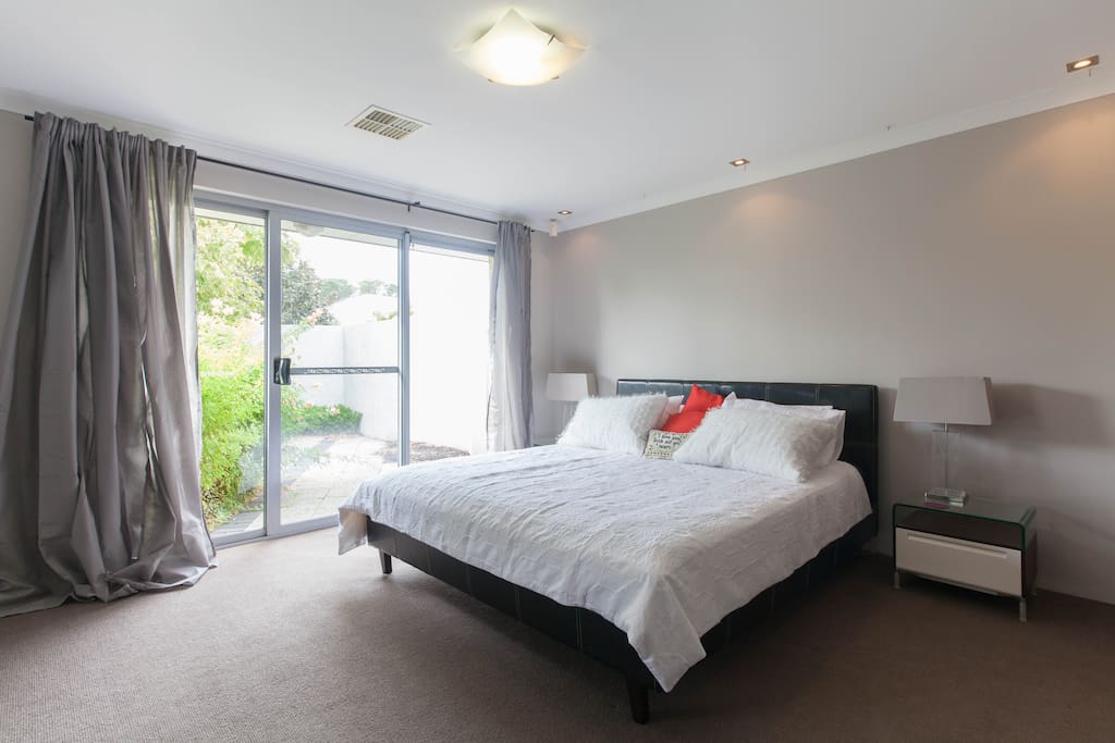 The master bedroom has a king size bed and also has a sliding door out onto the garden