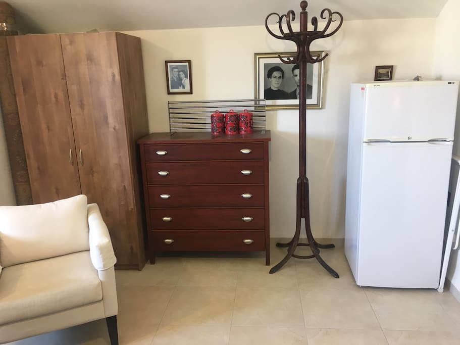 Couple suite with a closet and refrigirator