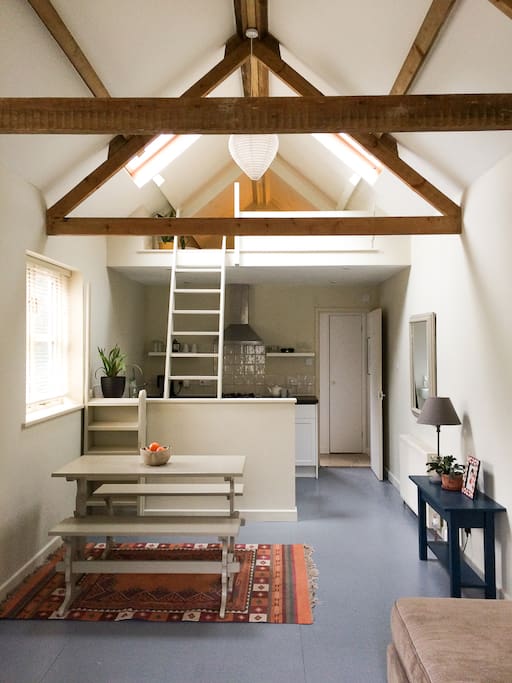 Dining area and kitchen leading with sleeping area above