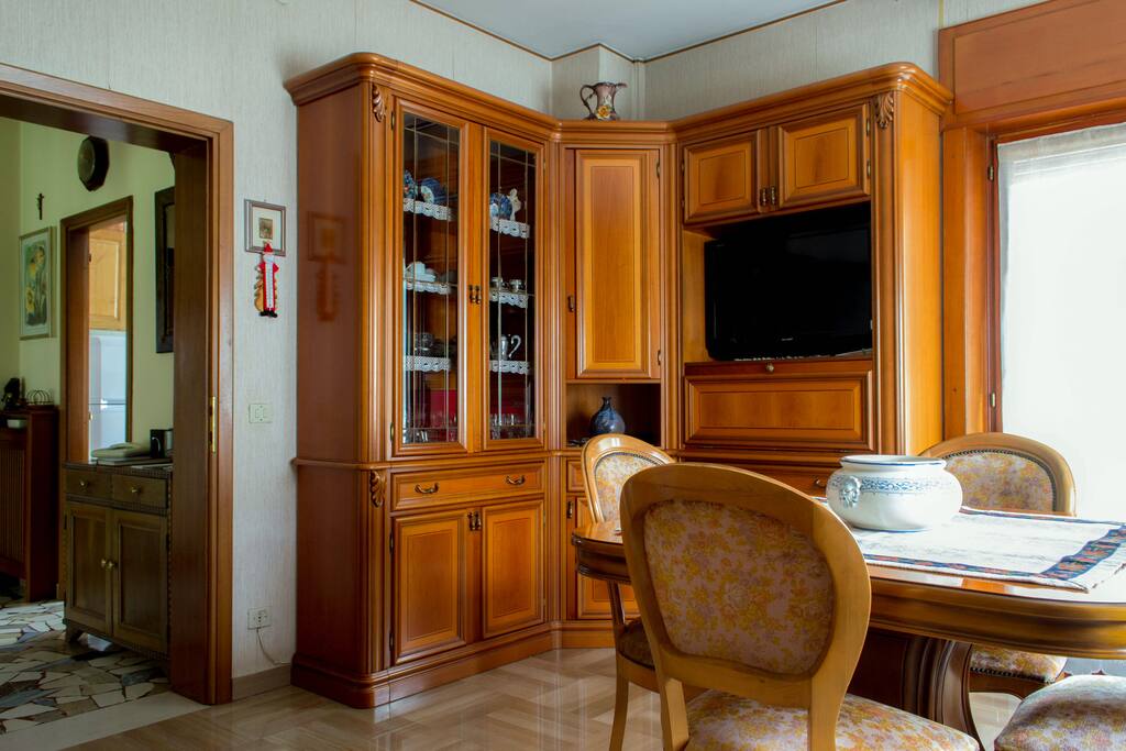 Living room with LCD Tv and comfortable sofa. Nice balcony