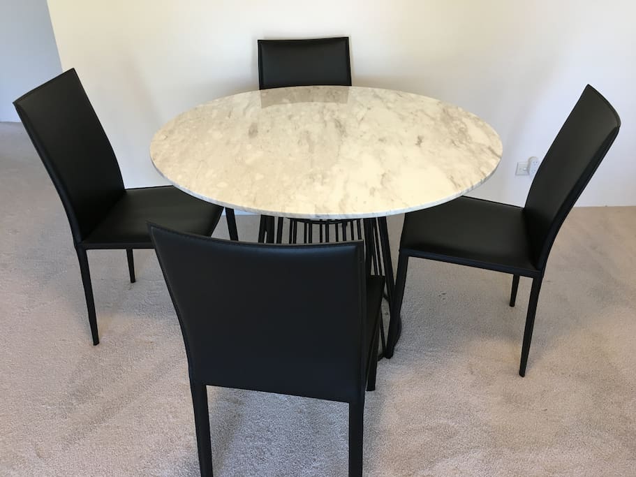 Marble dining table with leather chairs