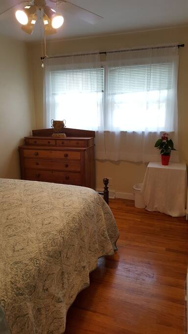 Sunny room. Blinds on windows. 6 drawer dresser for guest use.
