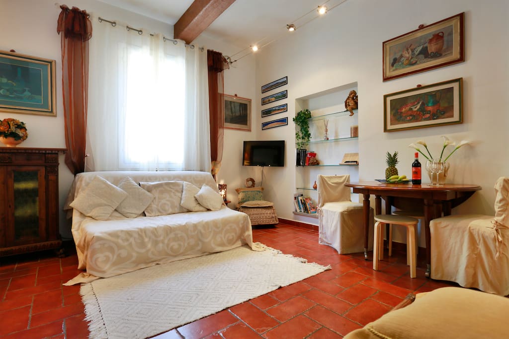 living room with kitchen table and sofa bed