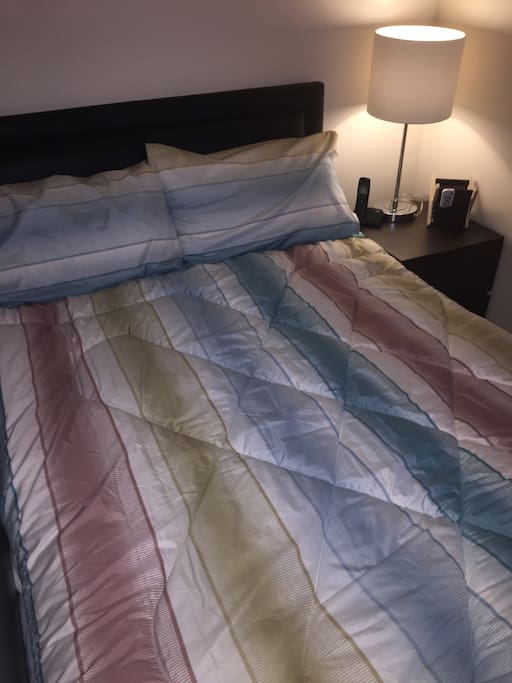 Comfy double bed with comforter.
