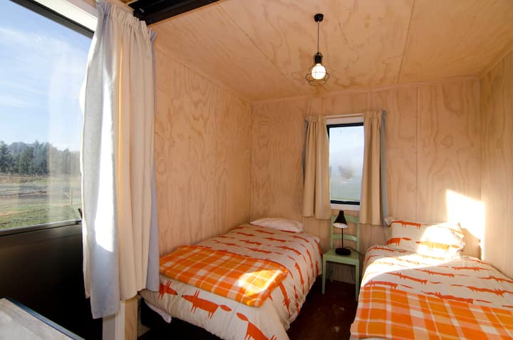 Twin room, warm duvets for winter, loads of blankets and even wool blankets curtains! Space for hanging clothes and placing bags. Books and toys too.