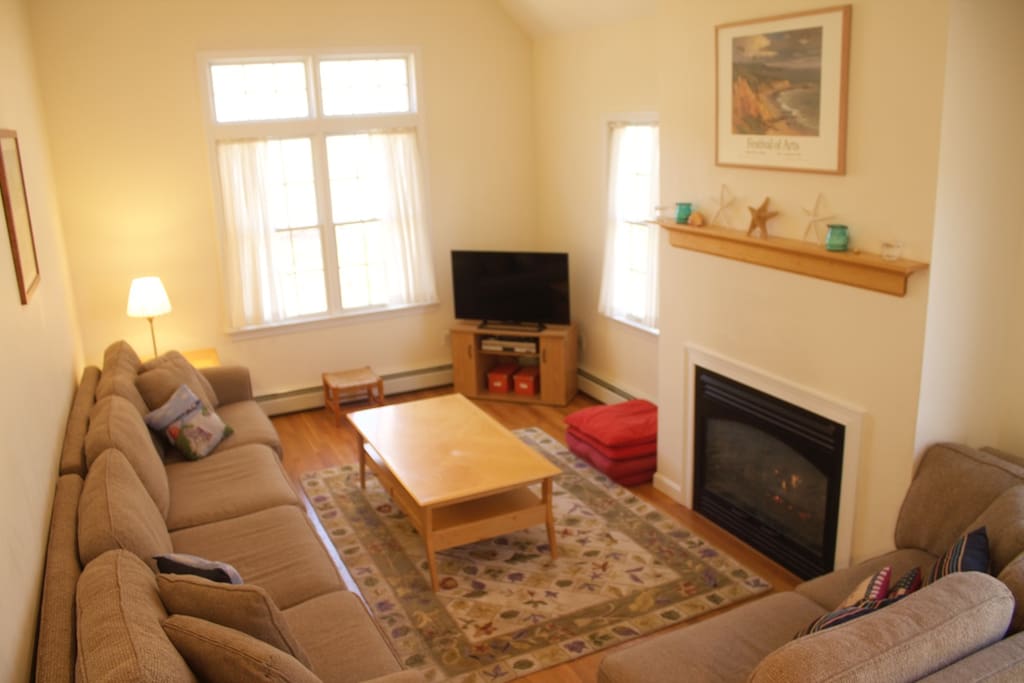 Living room with fireplace, open concept with balcony above
