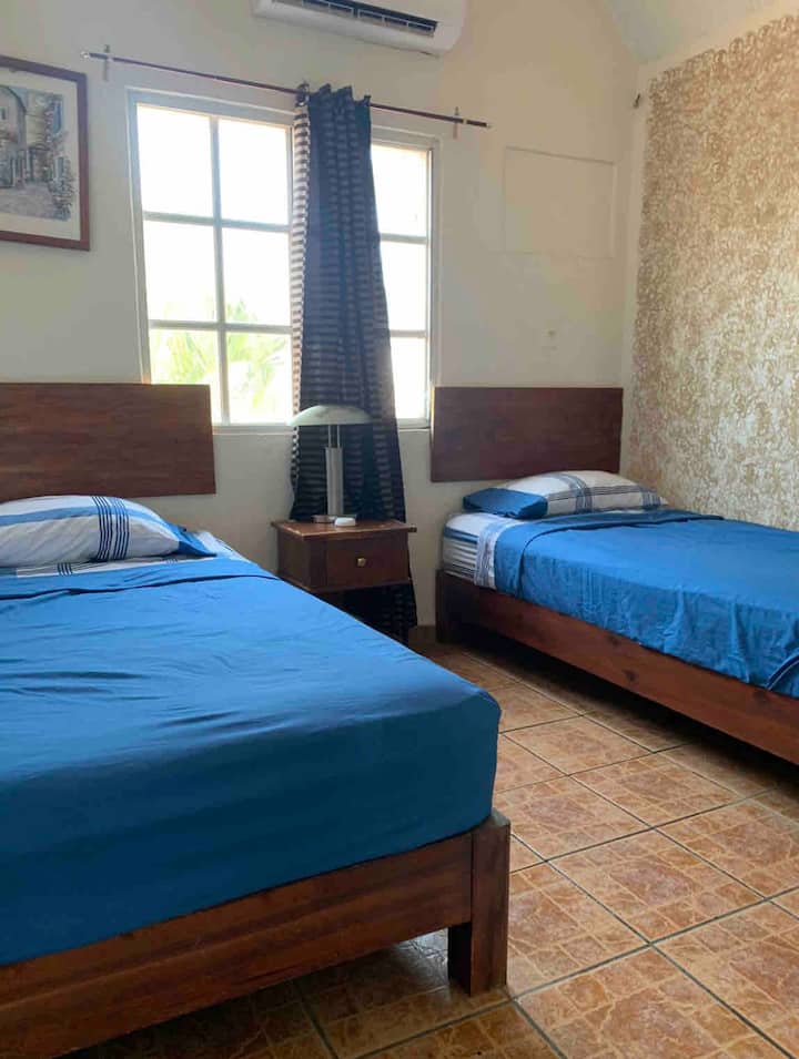 2号卧室位于上层，带2张单人床、空调（ Minisplit ）、吊扇和衣柜。 