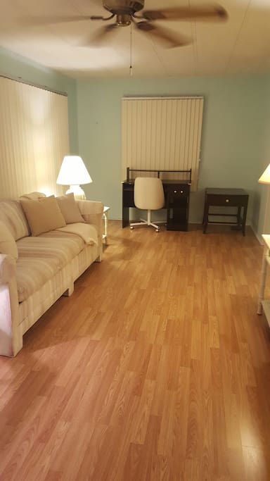 Large inclosed Florida room with writing desk.