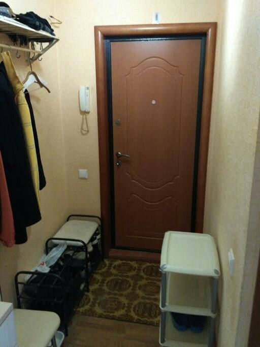 A spacious entrance hall with shelves for shoes and a hange