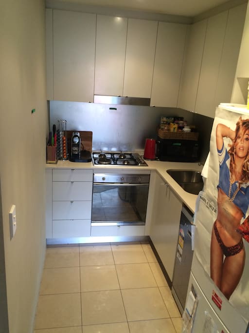 Modern kitchen with Smeg appliances and Nespresso machine available for use.