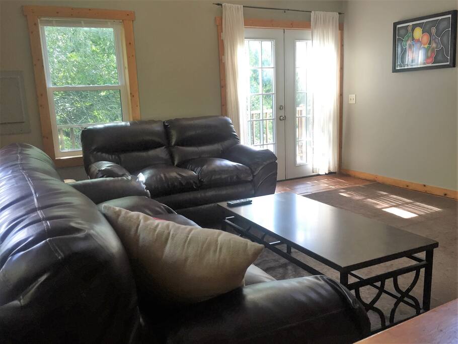 The living room has beautiful views! Relax and take in the nature that surrounds you, or spend some time on the wraparound deck!