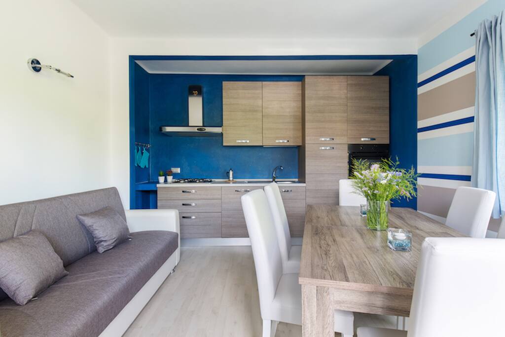 Bright living room with sofa bed and kitchinette