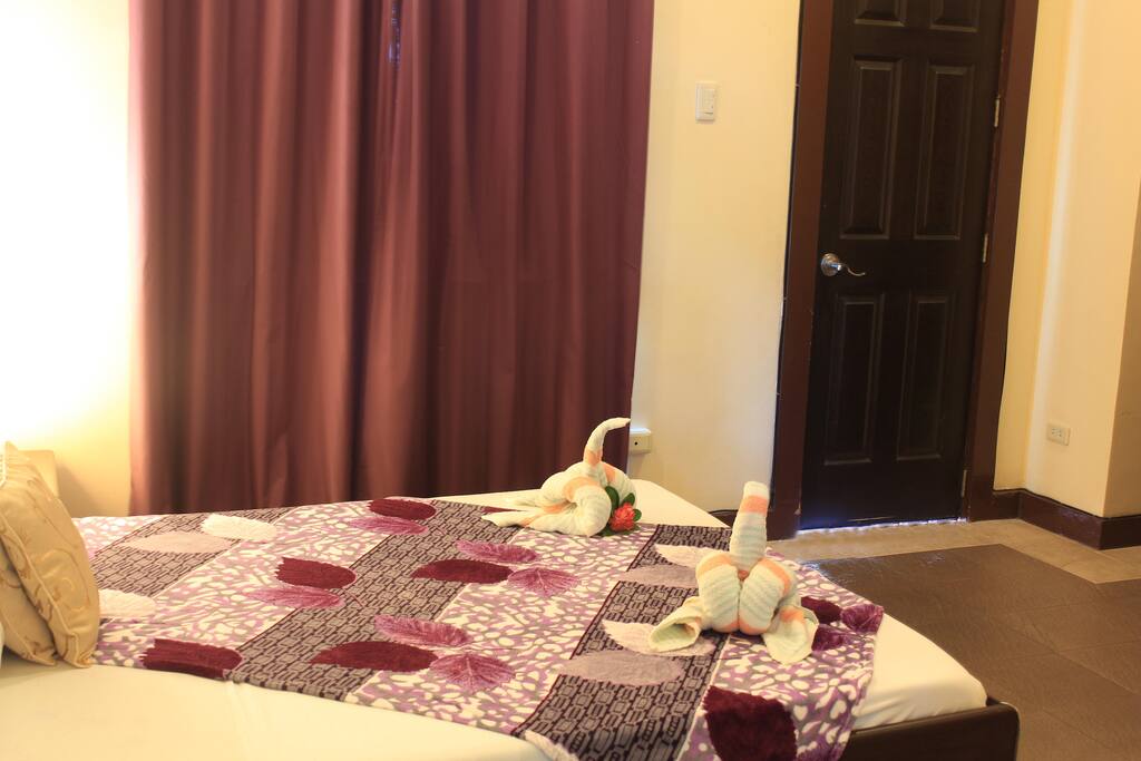 master bedroom with access to balcony to view the gardens and the forest beyond