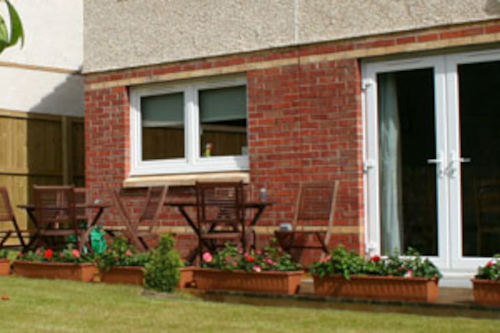 South facing back garden with chairs and table