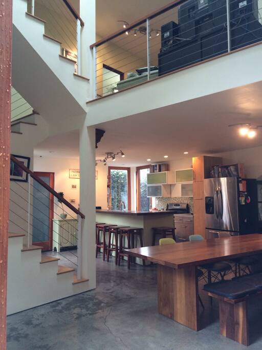 View of kitchen with counter that seats 6, stairs and, dining area