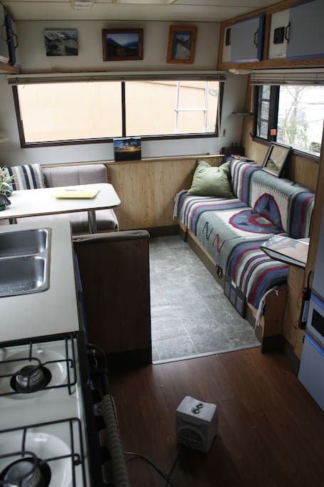 The Living Room, complete with booth table and couch, phone jack audio port with 5 speaker surround sound.