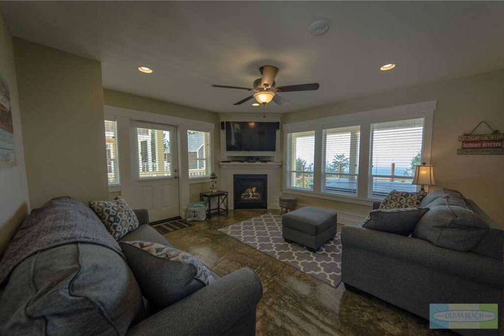 Media room on first floor with gas fire place, flat screen TV, and games