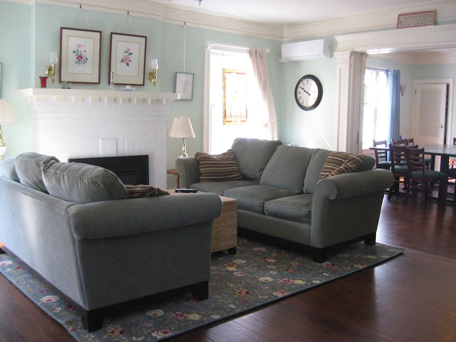 Spacious living room with working gas fireplace, lovely original hardwood floors.