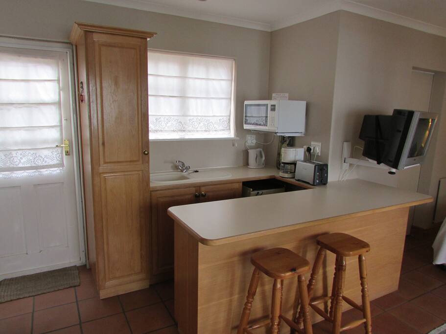 Kitchenette with fridge, sink, microwave, toaster, coffee machine, egg boiler,