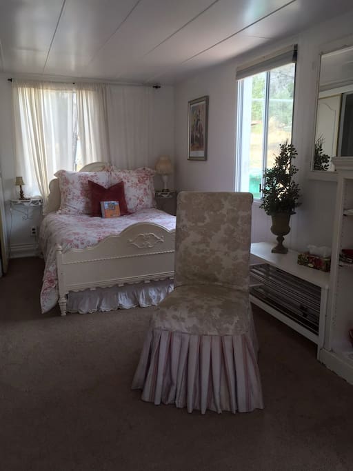 Petite Studio with shabby chic antique bed and chair.