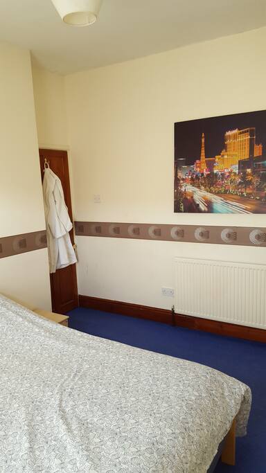 Bright, Comfy room with Double Bed and Luxurious Guest Bathrobe.