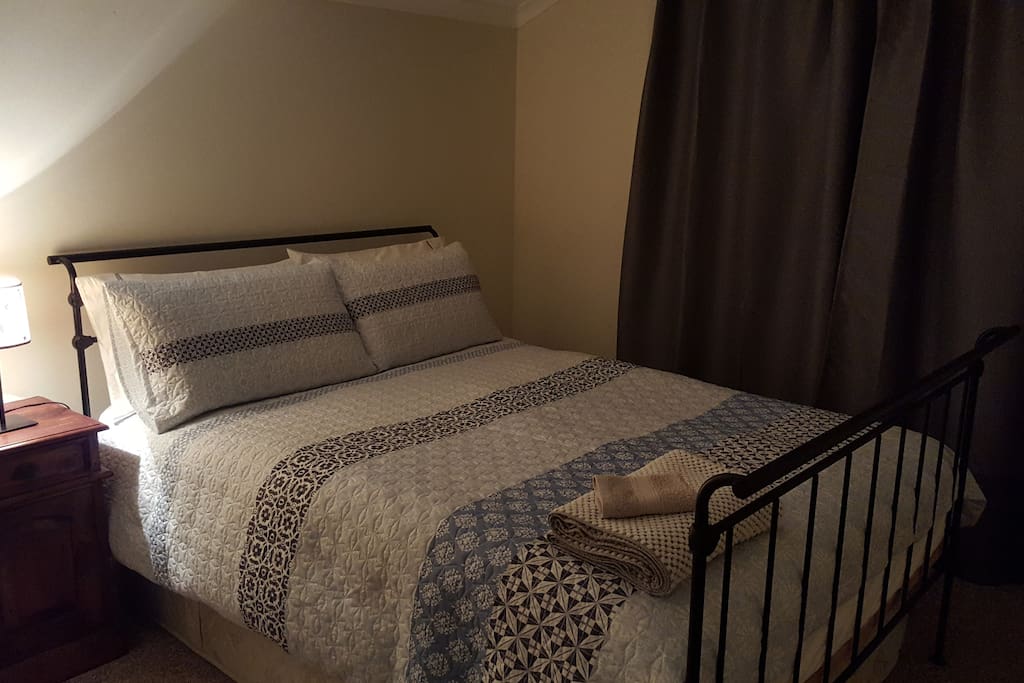 Bedroom with built-in robes and plenty of storage space. Door leads out to back yard.