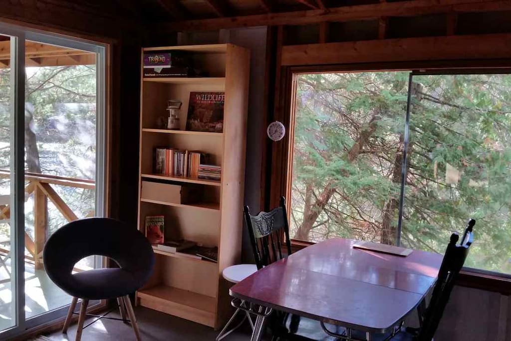 Dining table, books and games shelf.