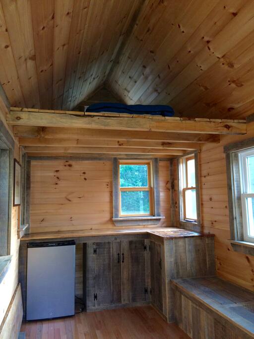 Sleeping loft above, counter space and long bench seat to relax on.