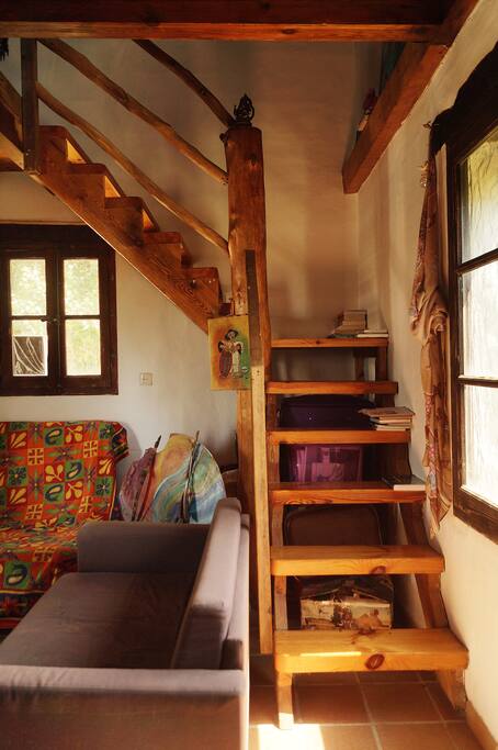 Beautifully constructed staircase takes you to the second storey with an open plan bedroom with two double beds.