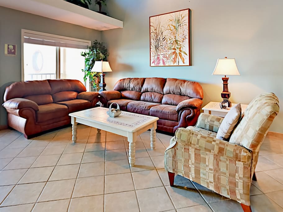 The condo is sprinkled with beach-inspired decor, and boasts vaulted ceilings, and tile flooring throughout.