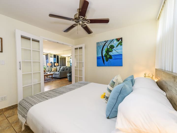 Fresh clean bedroom with tropical coconut painting