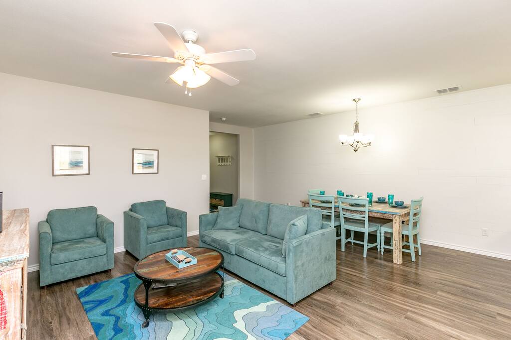 Cool ocean-inspired colors adorn the open-concept living and dining area