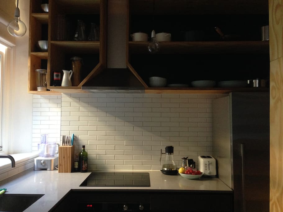 Kitchen with modern appliances including filtered water and dish draws.