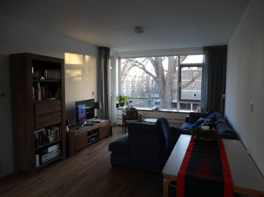 Other side of the living room with a large corner sofa and flat-screen television
