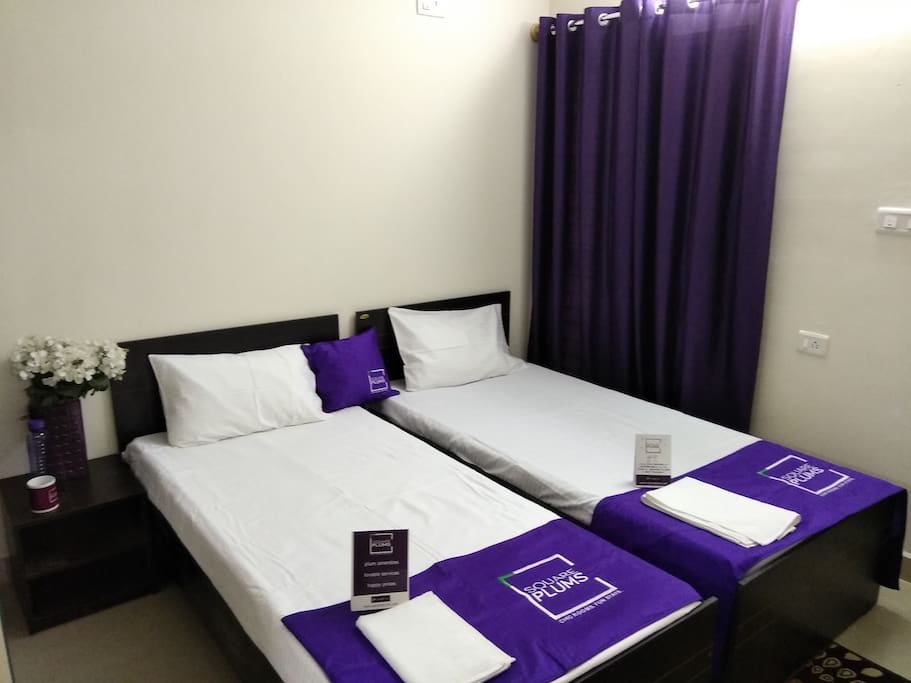 Bedroom with 2 single beds, wardrobes, private bathroom