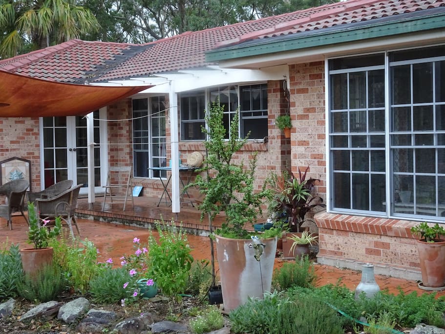 Gorgeous established gardens surround the home.
