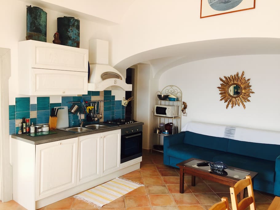 Salotto con cucina e divano letto/Living room with kitchenette and divan bed