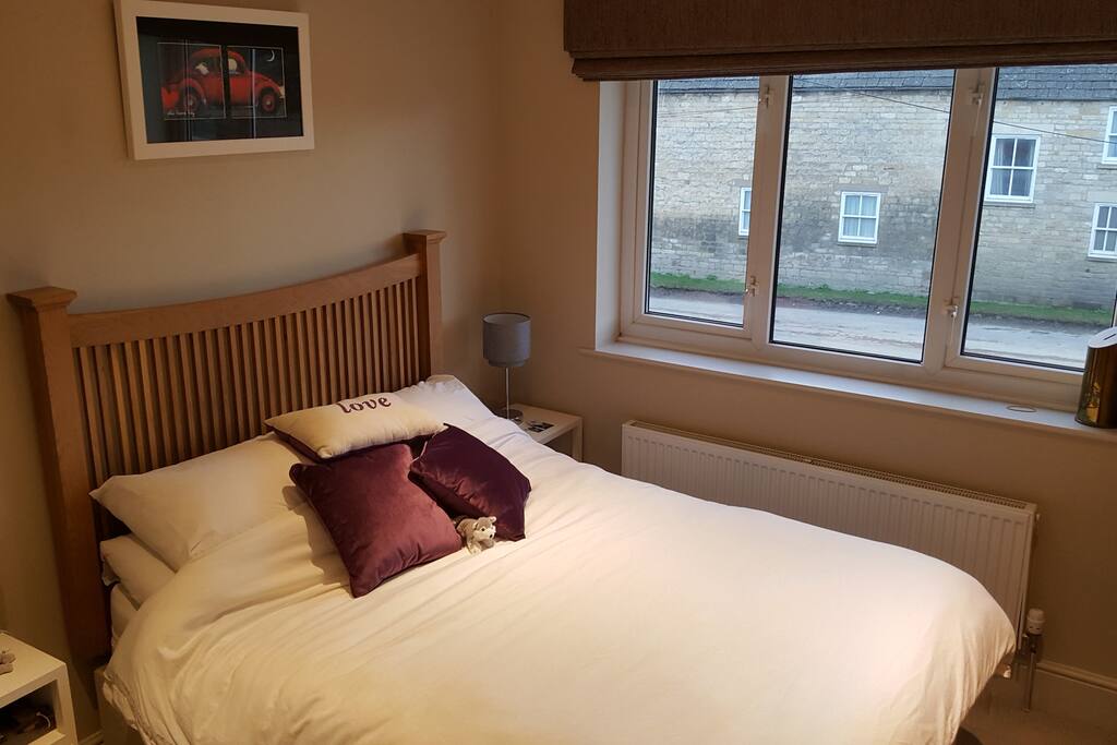 Clean and airy double bedroom with bedside cabinets and clothes storage